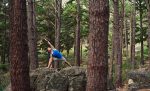 Man Doing An Extending Side Angle Pose In The Woods